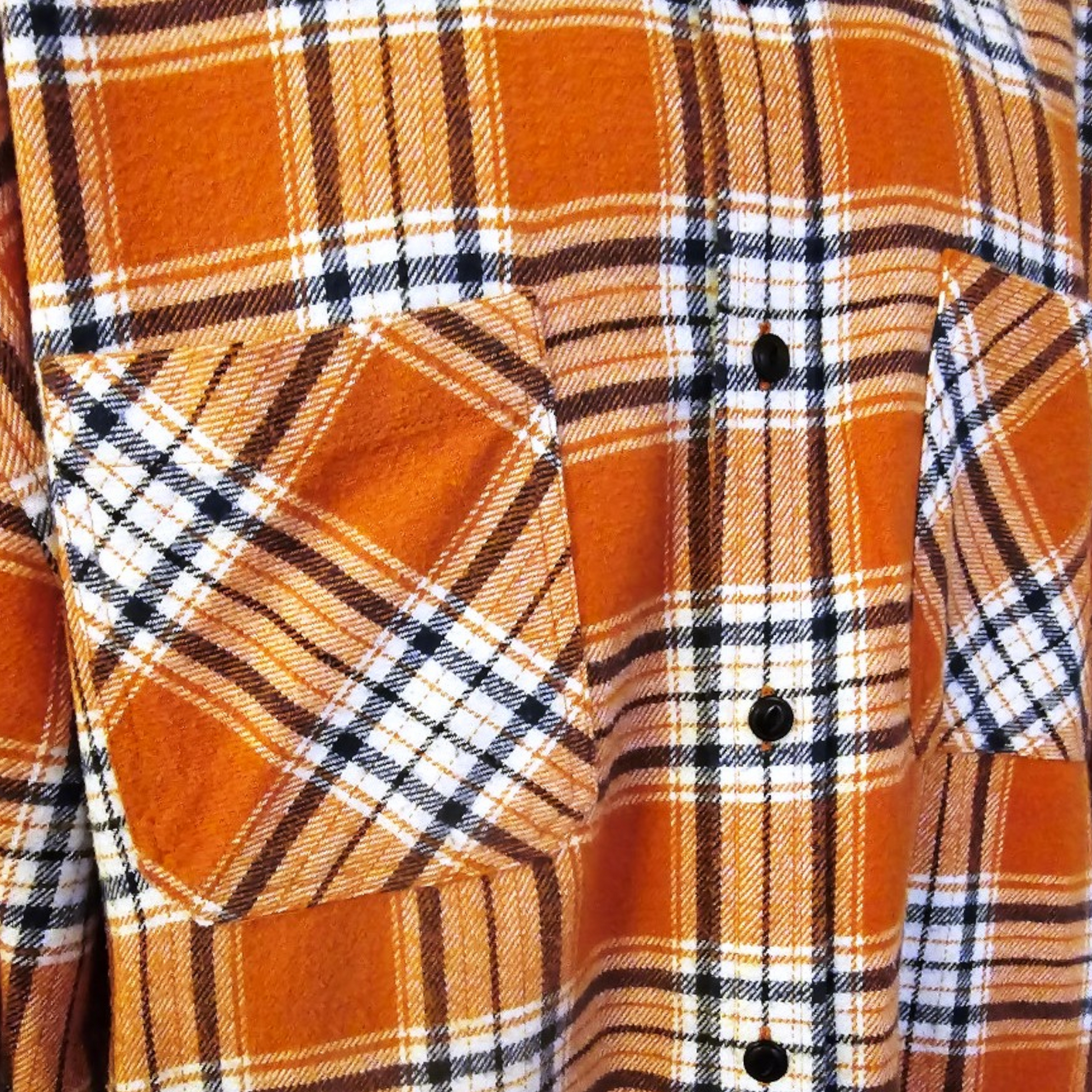 Close-up of an plaid shirt with a pocket and buttons.