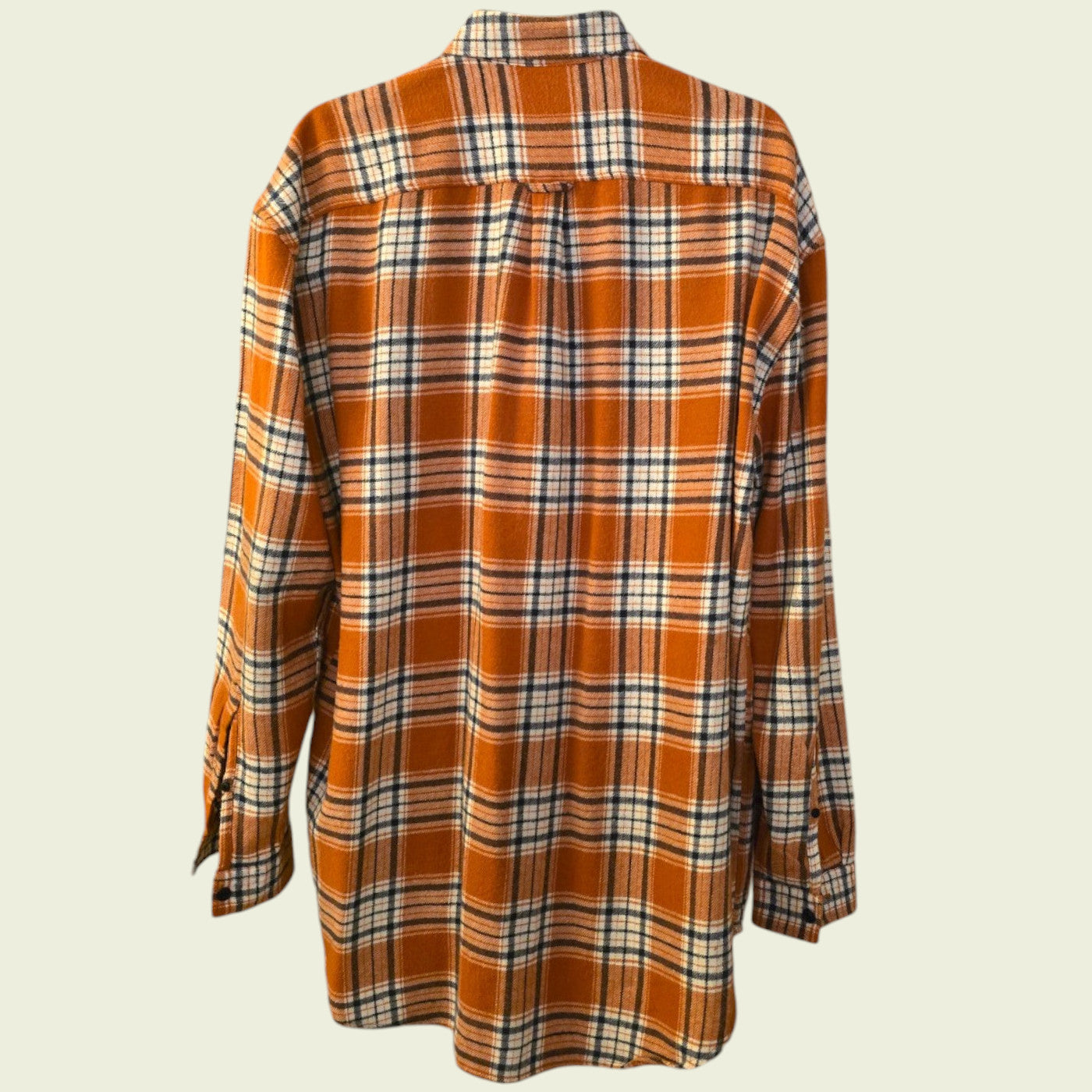 Plaid shirt with orange and brown pattern on a beige background