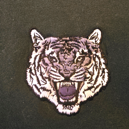 Embroidered tiger patch on a dark background