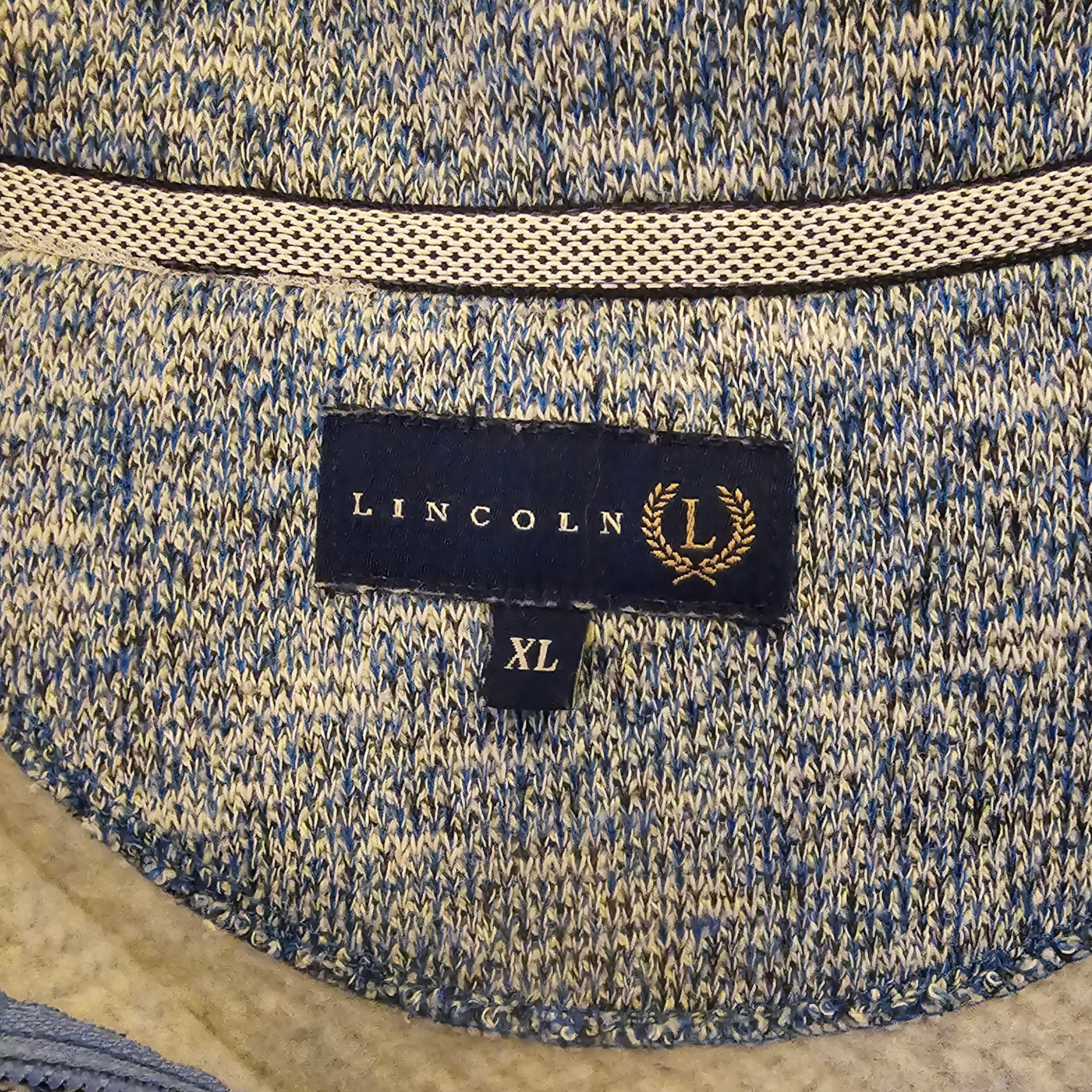 Close-up of a blue and beige textured fabric with a Lincoln label on it.