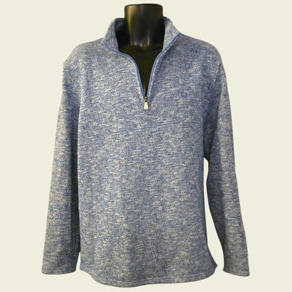 Blue knit sweater on a mannequin against a light background