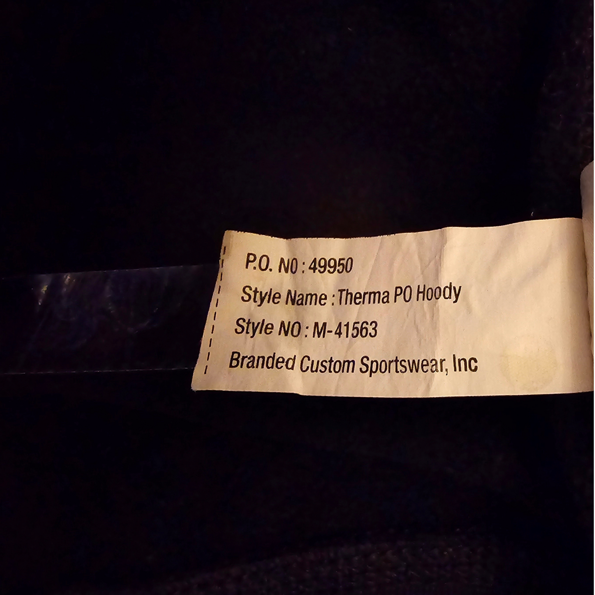 Label on a garment with text including a product number, style name, and brand name.