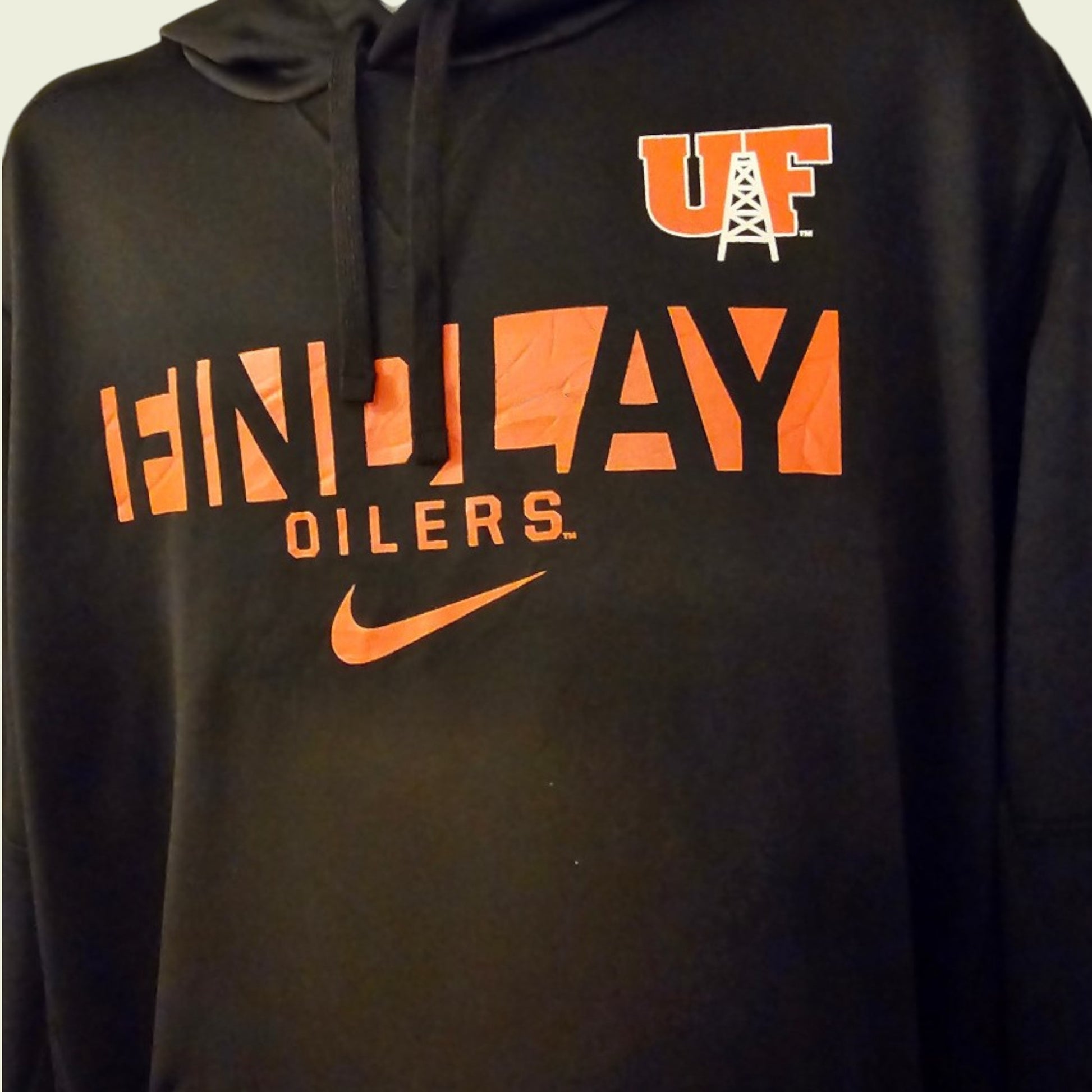 Black hoodie with orange and white text and logos on a plain background
