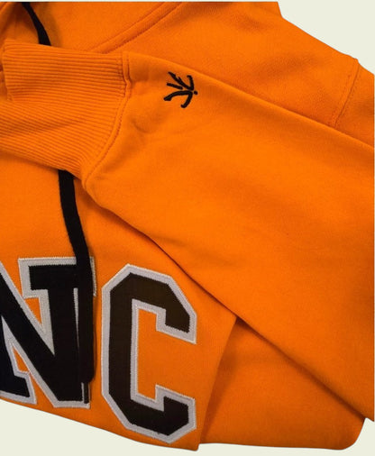 Orange hoodie with black lettering and logo on a beige background