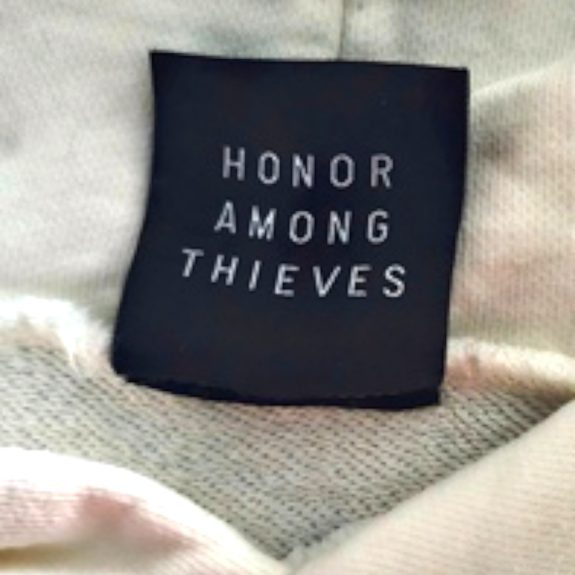 Black label with 'Honor Among Thieves' text on a textured surface