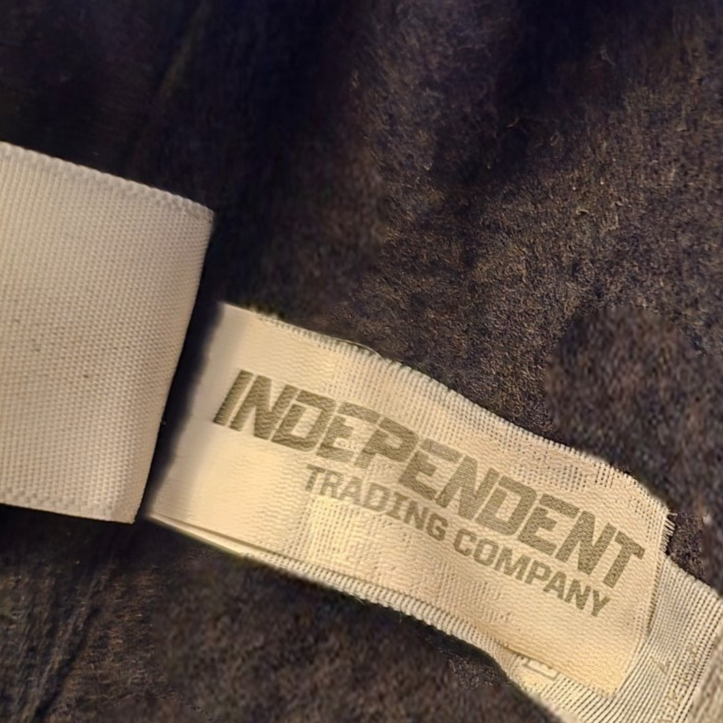 Label on a brown fabric product with 'Independent Trading Company' text.