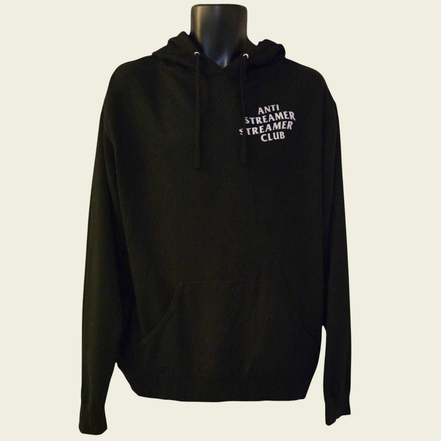 Black hoodie with text on a mannequin against a beige background