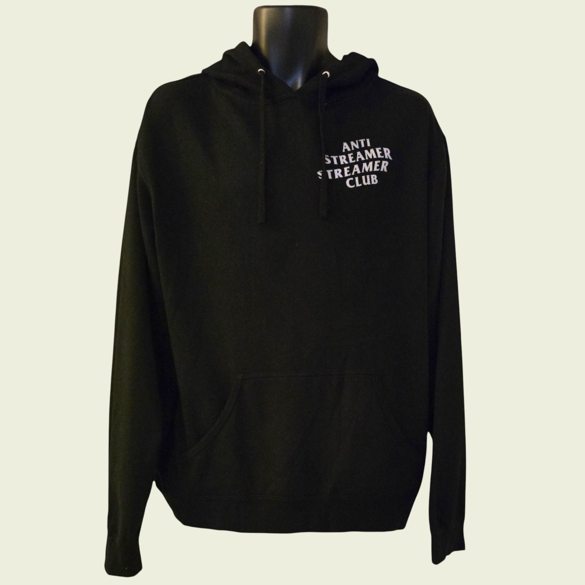 Black hoodie with text on a mannequin against a beige background