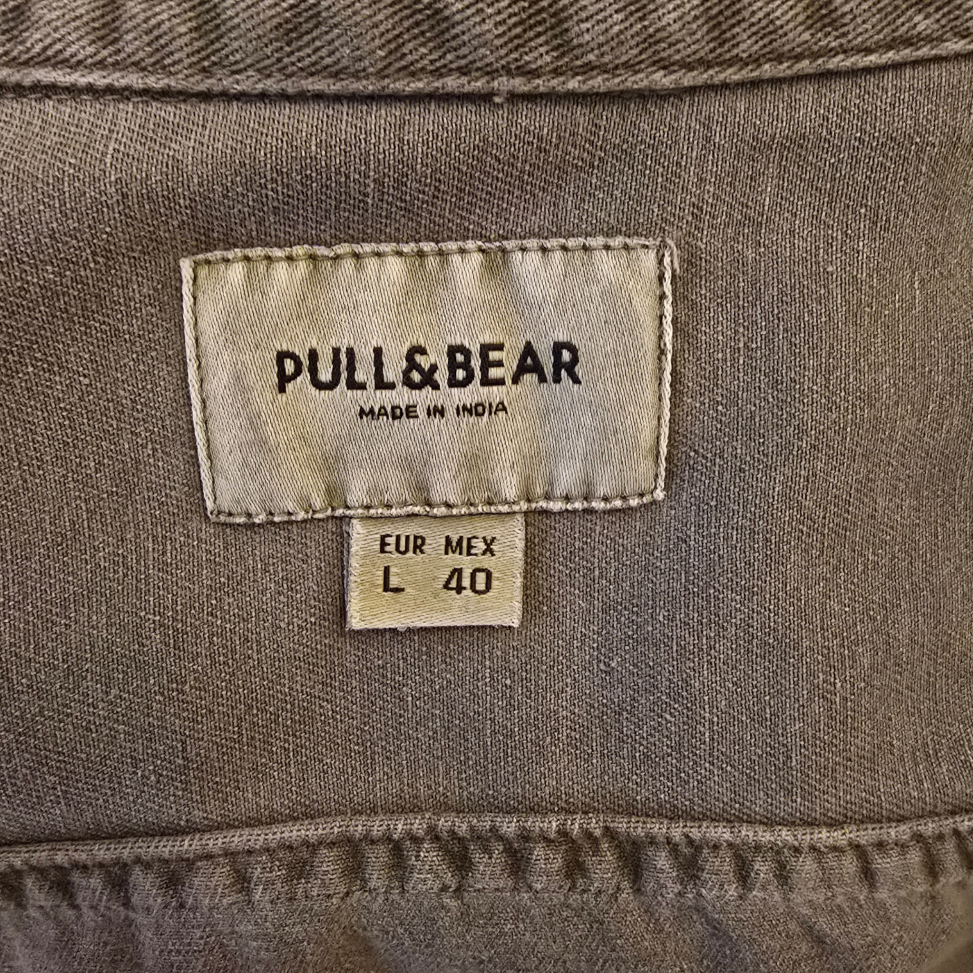 Close-up of a Pull&Bear label on a brown fabric background