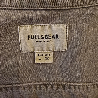 Close-up of a Pull&Bear label on a brown fabric background