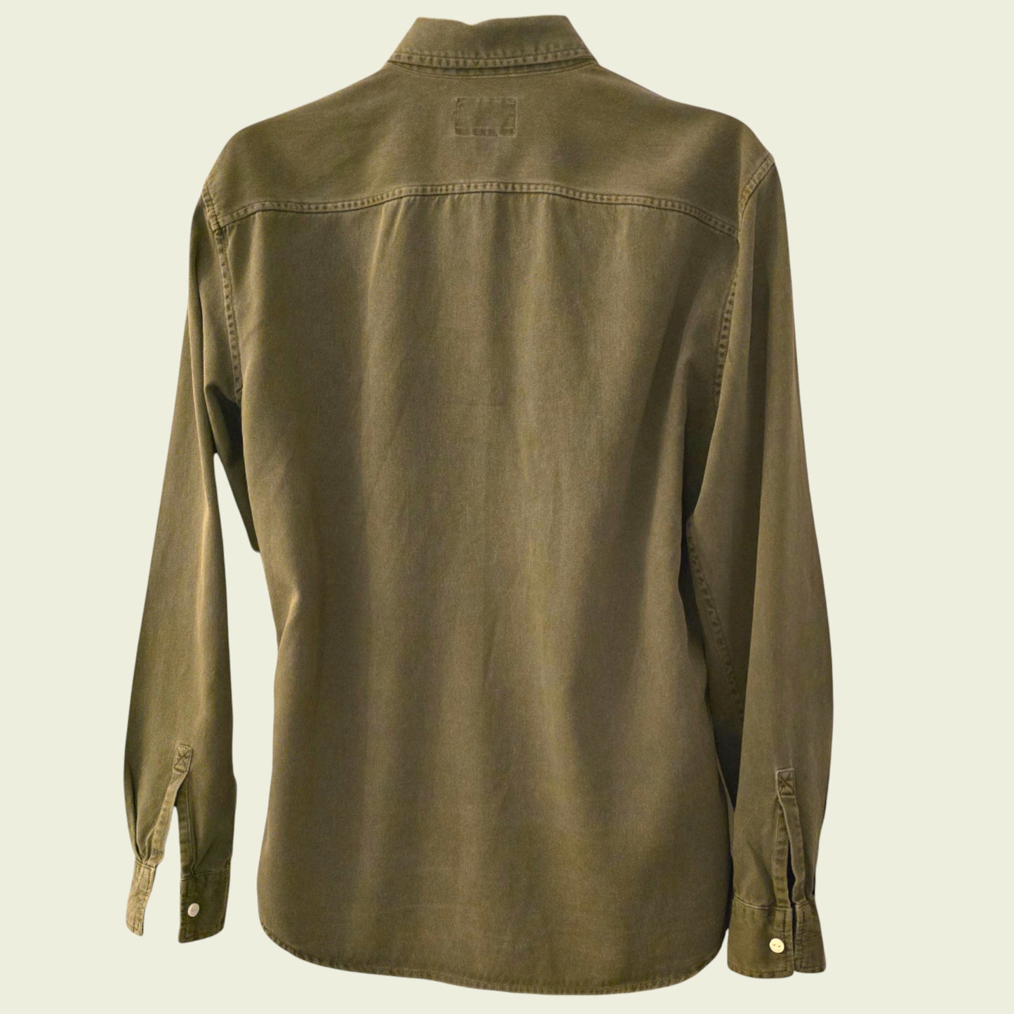 Green shirt on a beige background