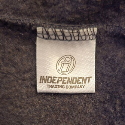Label with 'Independent Trading Company' on a textured fabric background