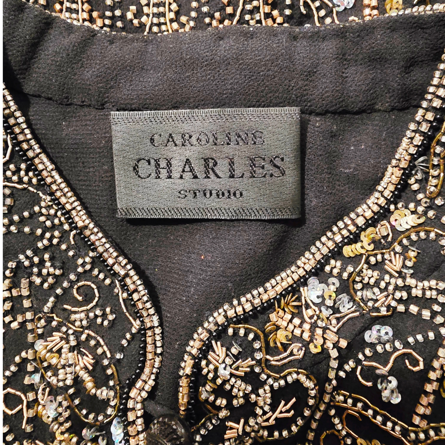 Embroidered garment with 'Caroline Charles Studio' label
