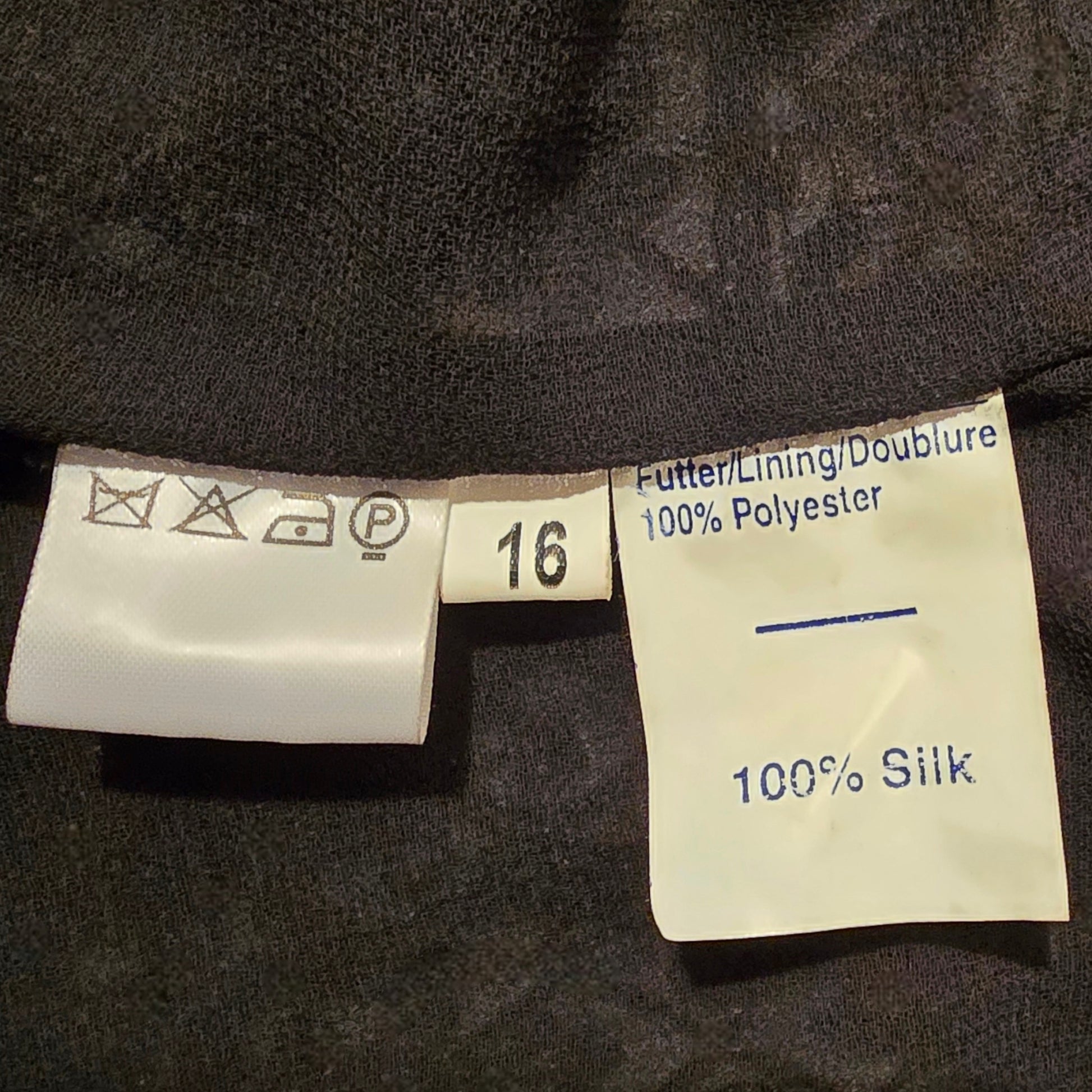Clothing labels on a dark fabric background