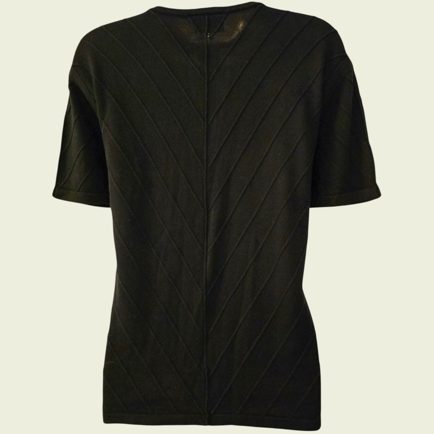 Black textured cardigan on a beige background