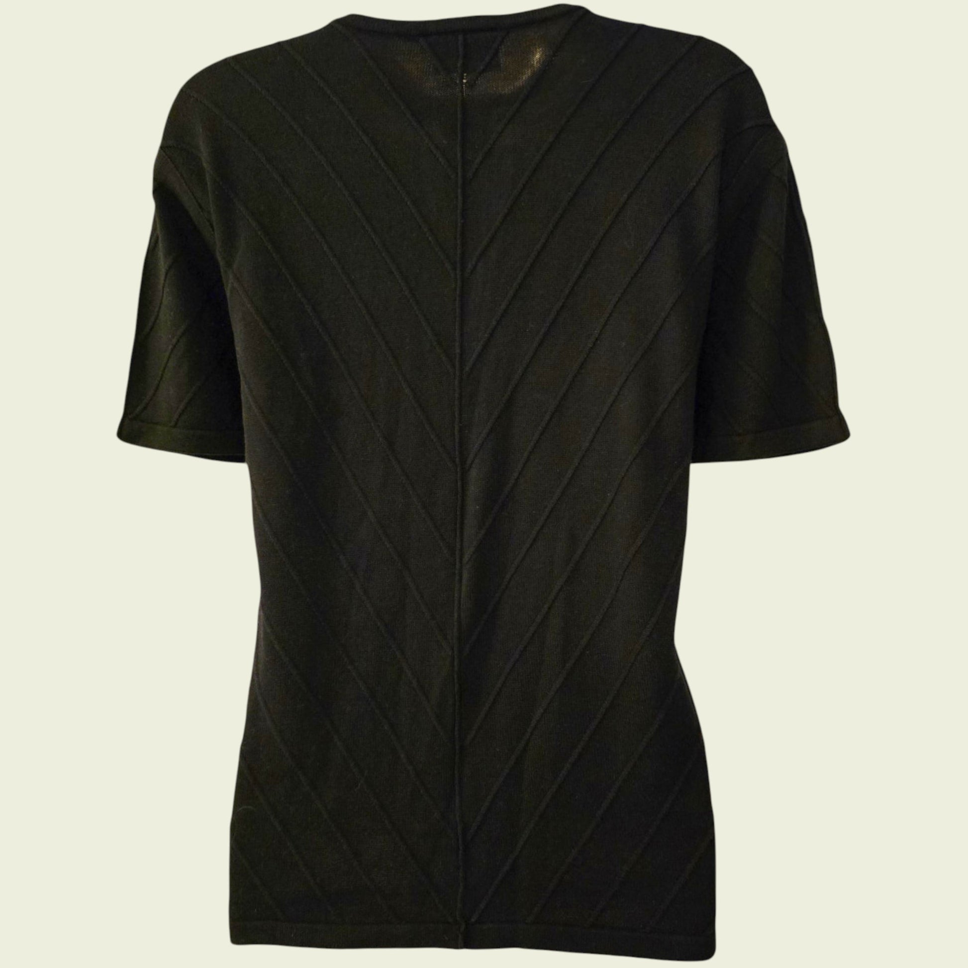 Black textured cardigan on a beige background