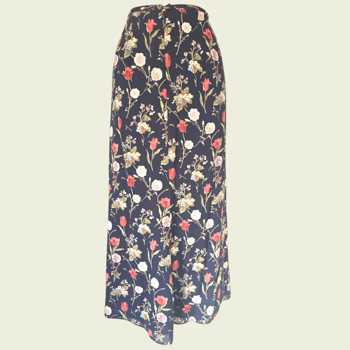 Black floral skirt on beige background