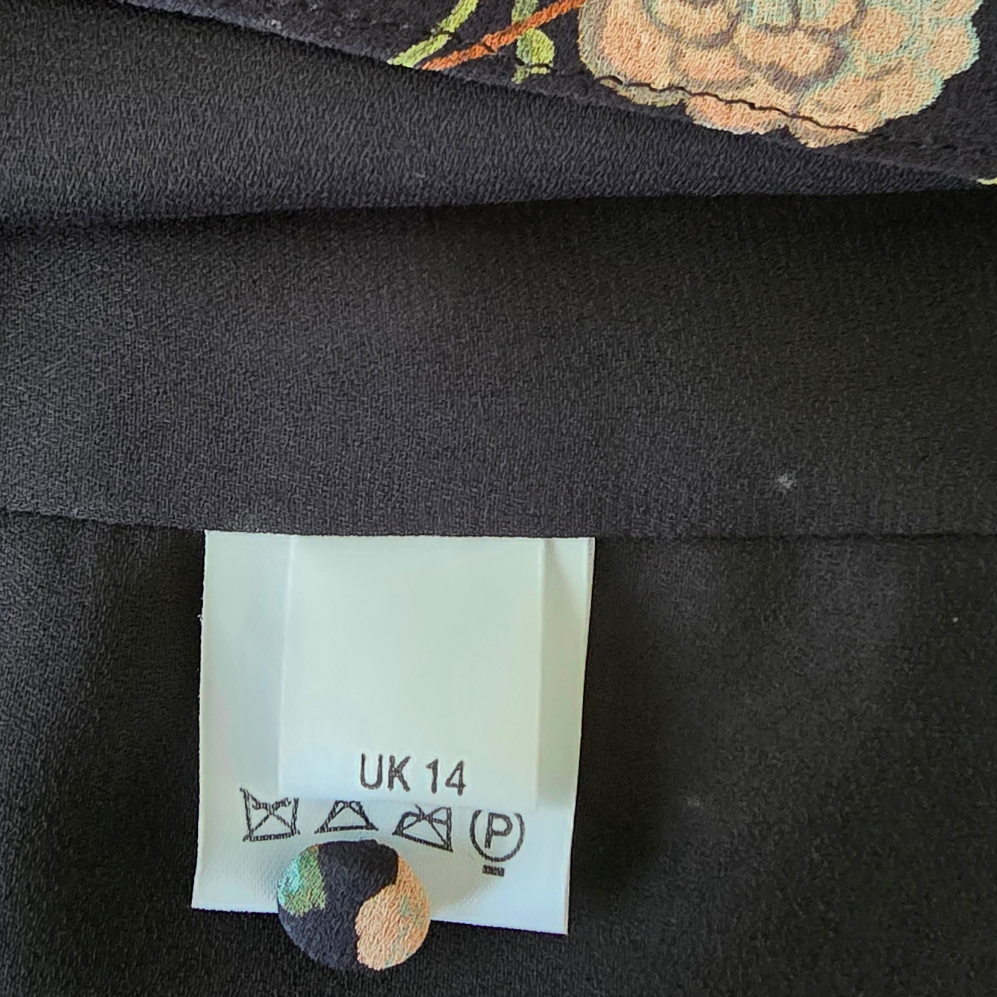 Garment label showing size on black background