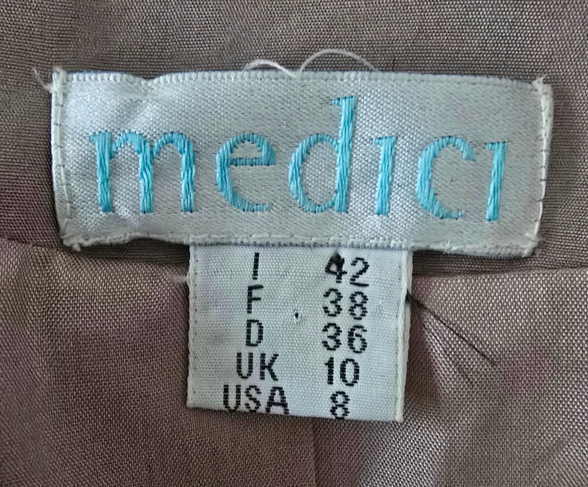 Label with 'medici' branding and size information on a fabric background