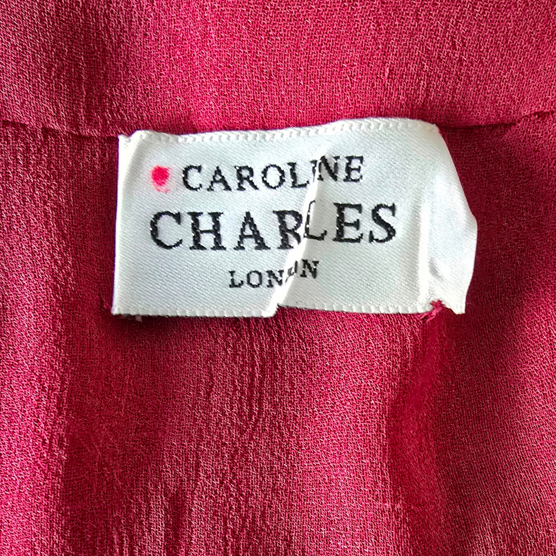 Clothing label with 'Caroline Charles London' on a red fabric background