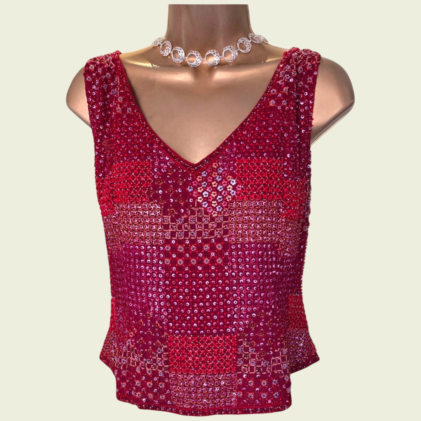 Red sequin top on a mannequin with a plain background