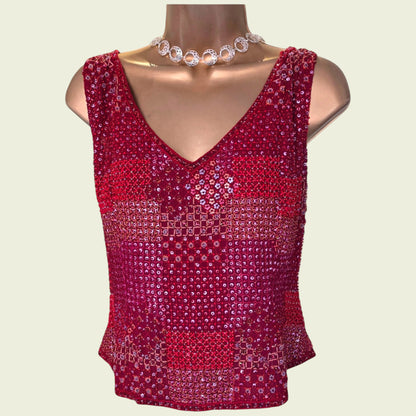 Red sequin top on a mannequin with a plain background