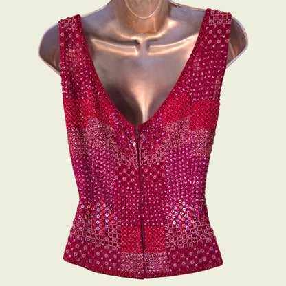 Red sequined top on a mannequin against a light beige background