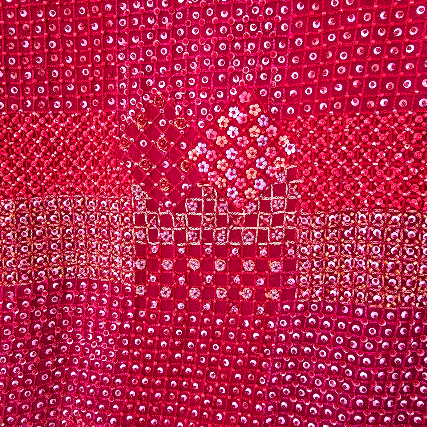 Close-up of a red fabric with a diamond pattern