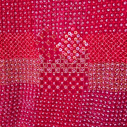 Close-up of a red fabric with a diamond pattern
