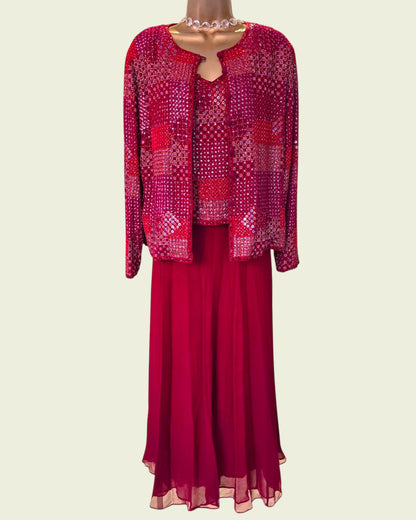 Red patterned jacket and skirt set on a mannequin against a beige background