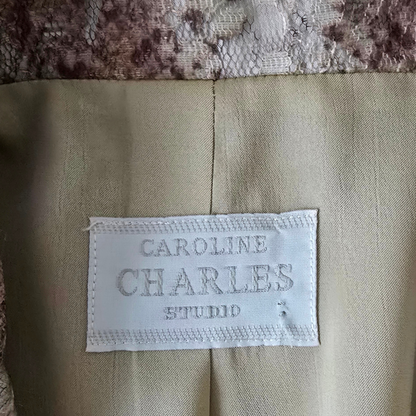 Label on a beige fabric with 'Caroline Charles Studio' text.