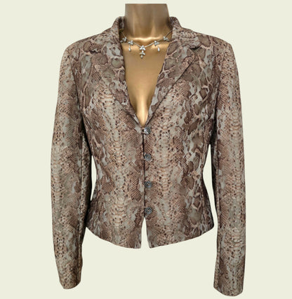 Snakeskin patterned jacket on a mannequin against a beige background