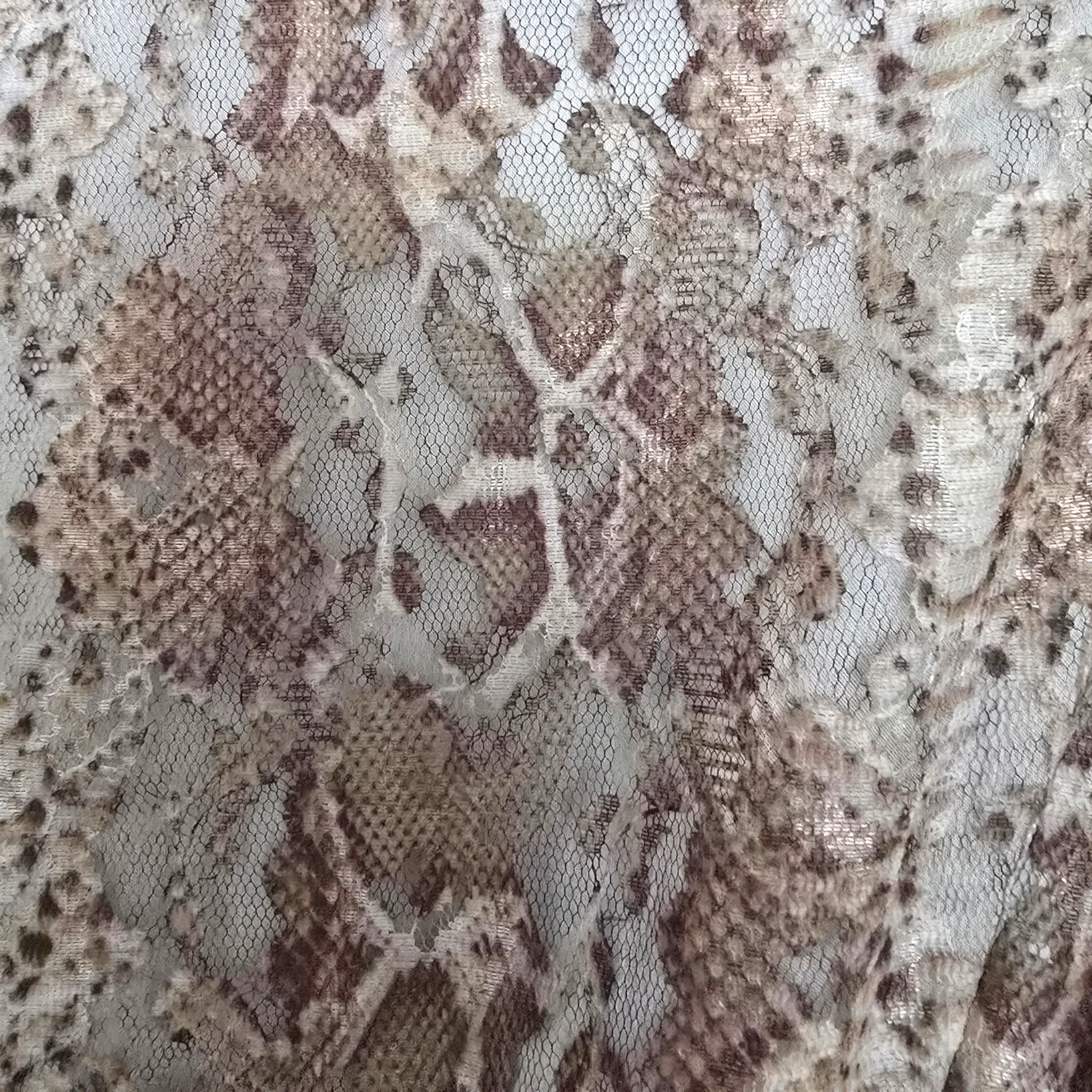 Close-up of snake skin patterned fabric with brown and beige colors.