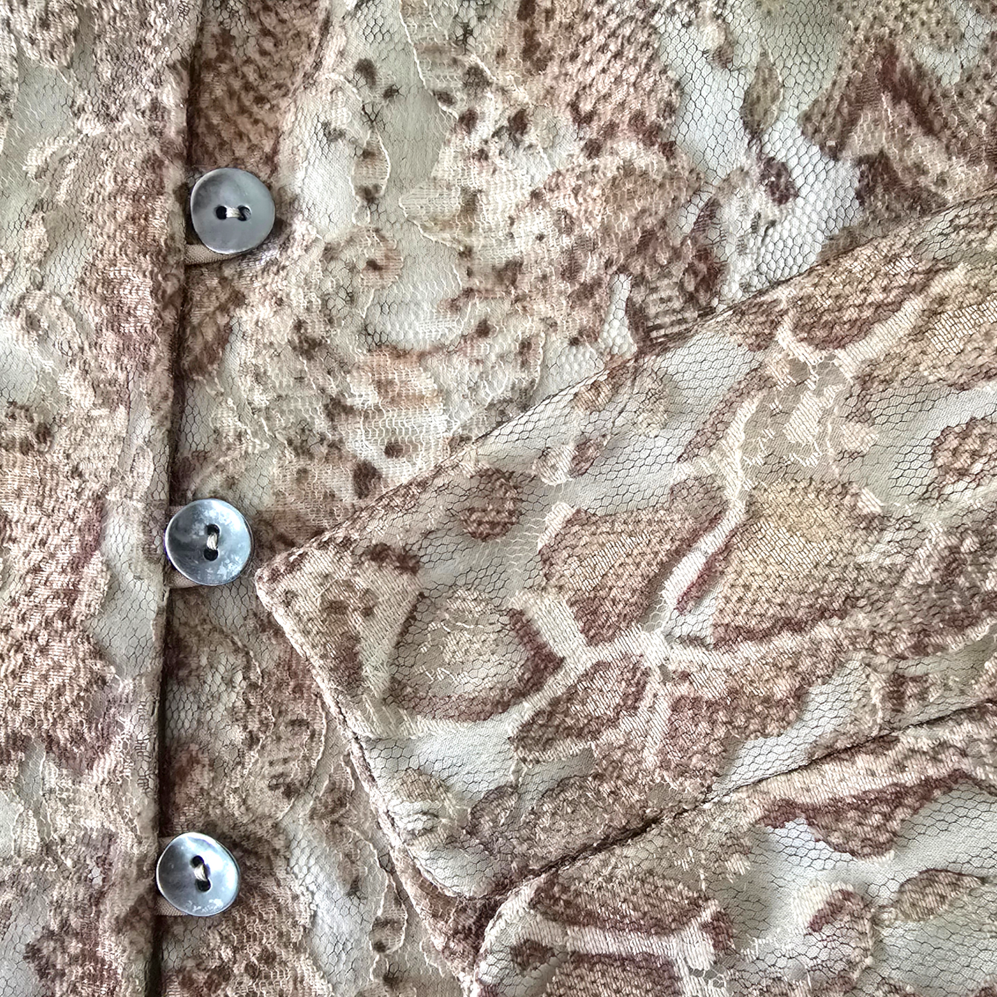 Close-up of a textured fabric with buttons on a patterned background