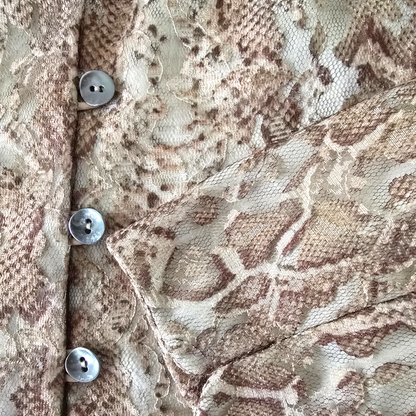 Close-up of a textured fabric with buttons on a patterned background