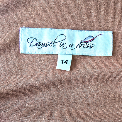 Fabric label with 'Damsel in a Dress' branding on brown fabric