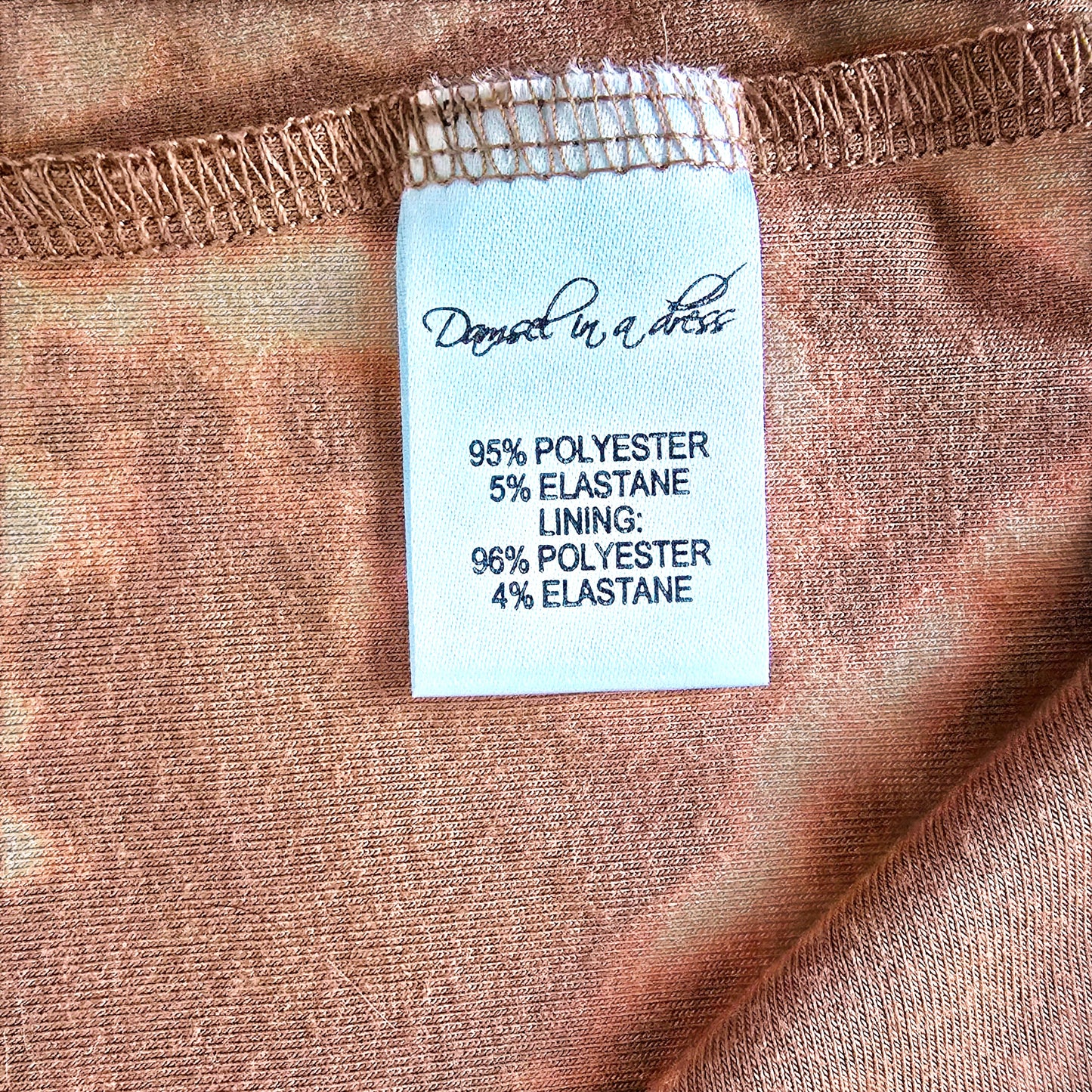 Fabric label with material information on a brown fabric background