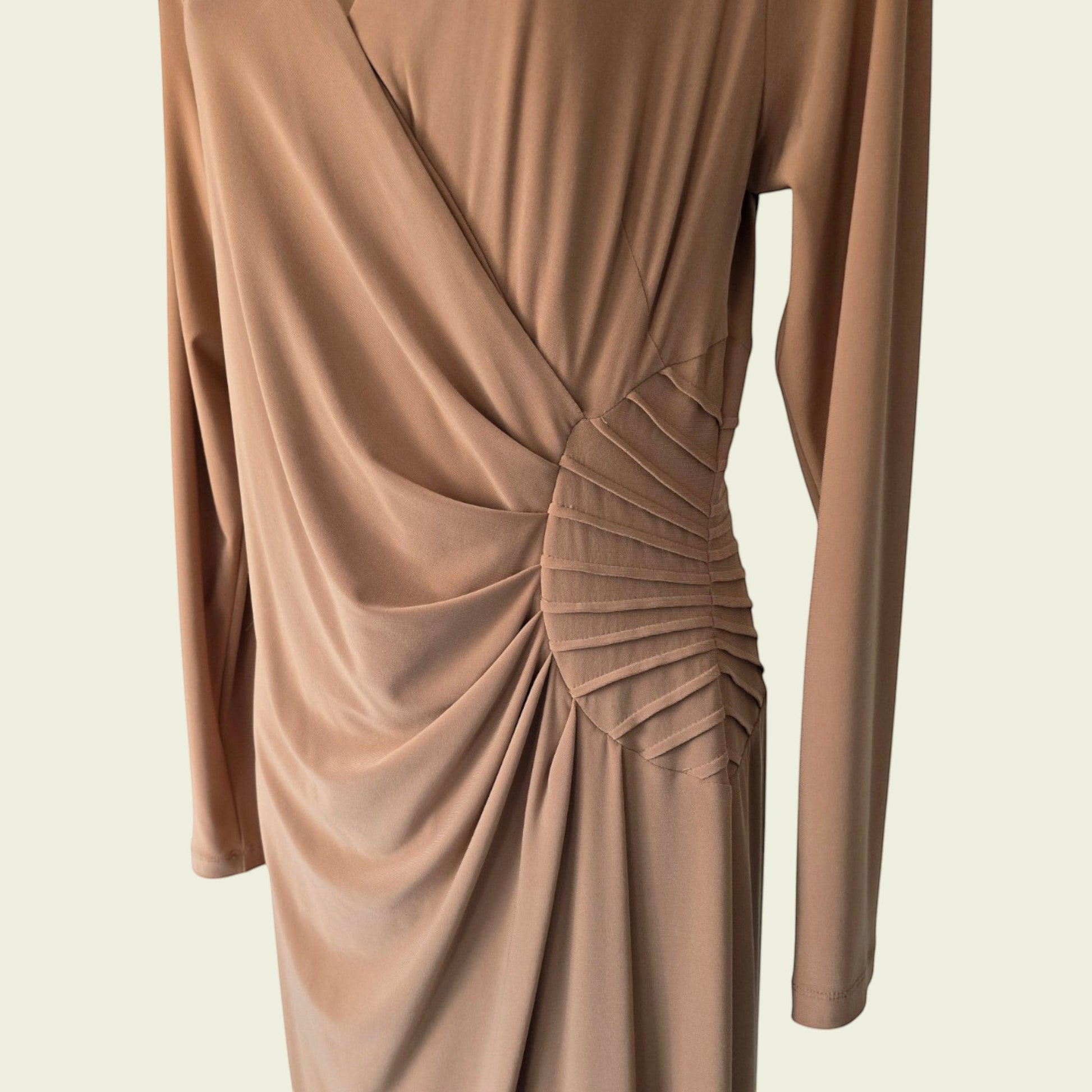 Brown long-sleeve dress with a knot detail on a beige background