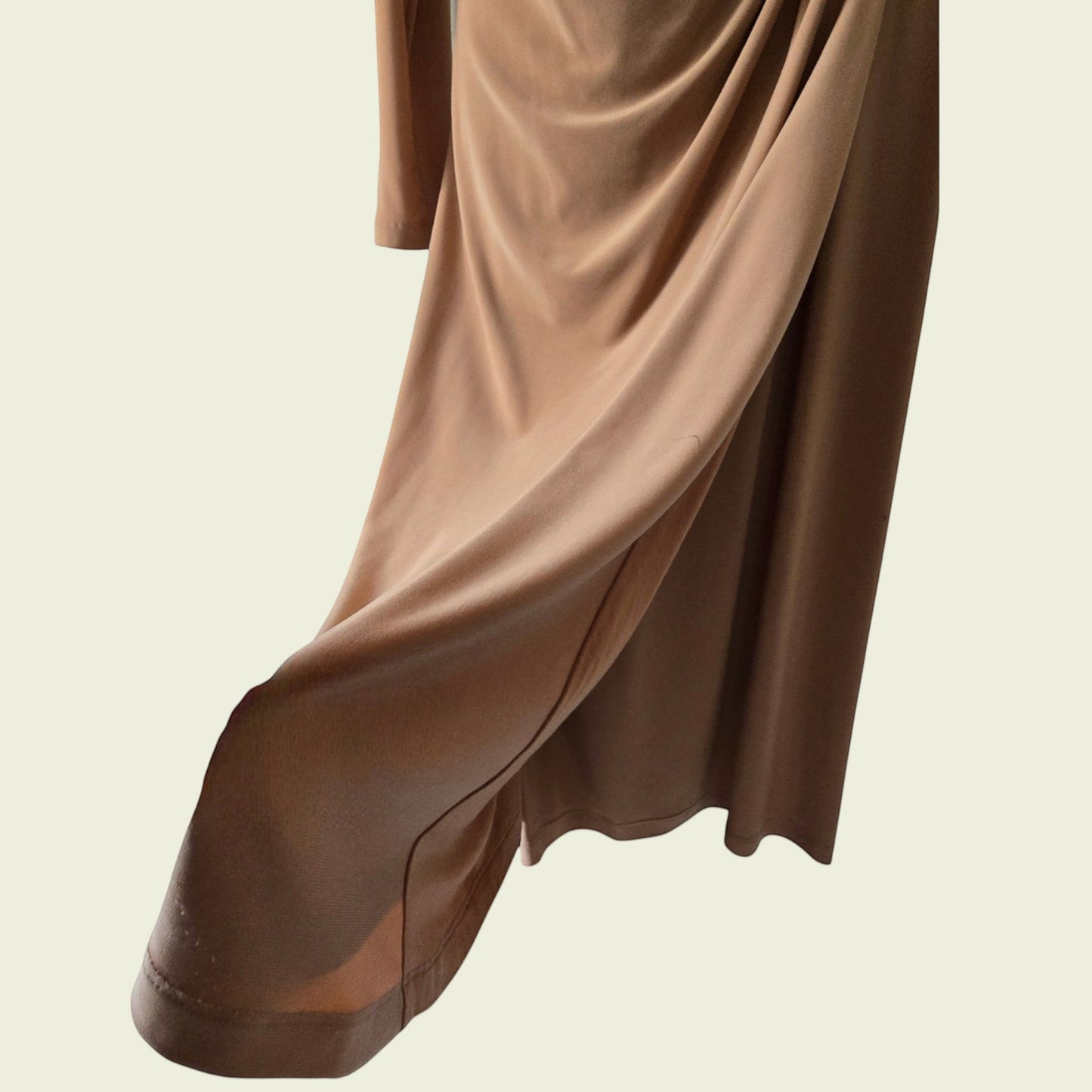 Brown dress showing side slit on a neutral background