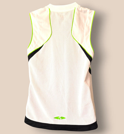 White sleeveless athletic top with green accents on a beige background