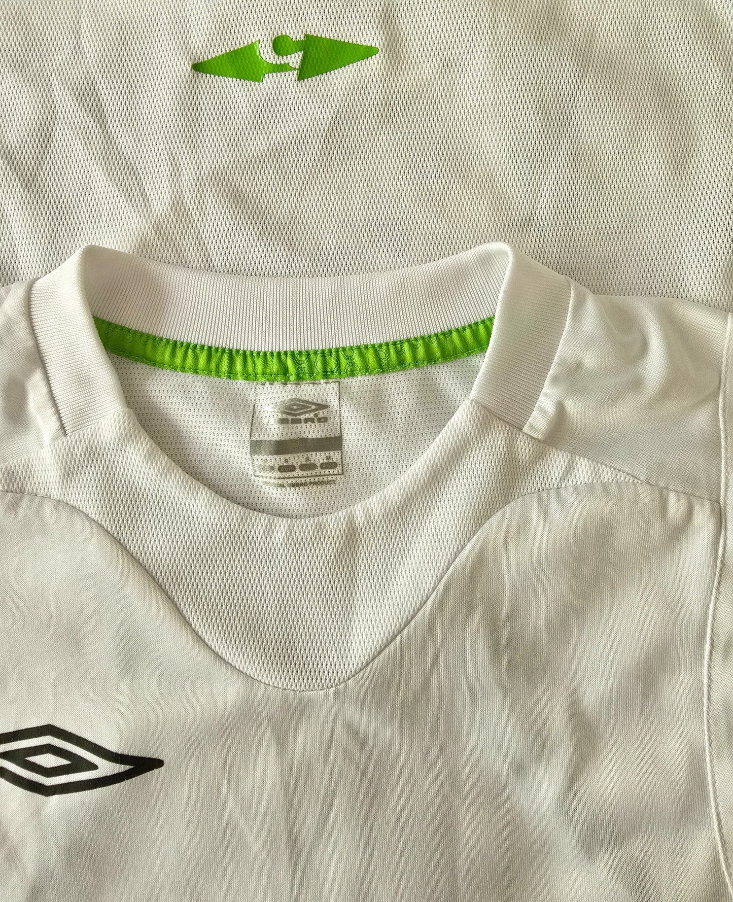 Close-up of a sports jersey with a brand logo on a beige background