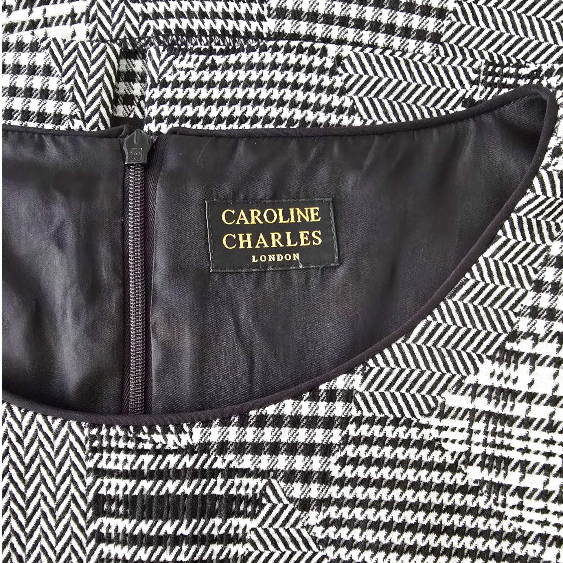 Close-up of a black and white patterned fabric with a visible brand label inside.