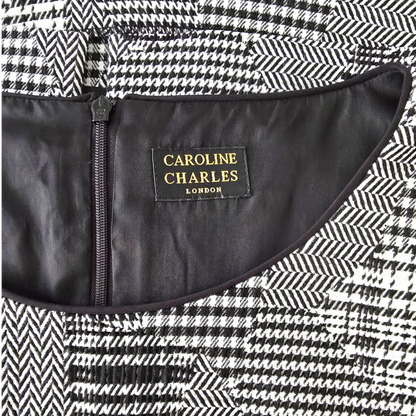 Close-up of a black and white patterned fabric with a visible brand label inside.