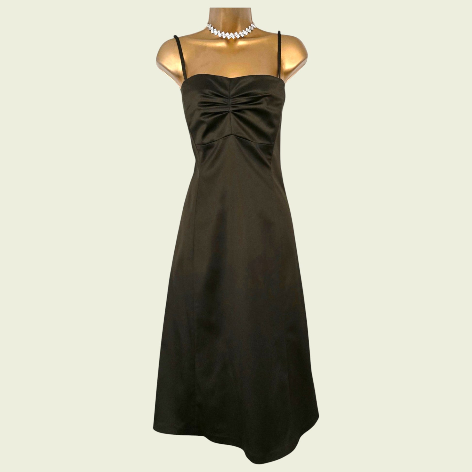 Mannequin wearing an olive green dress on beige background