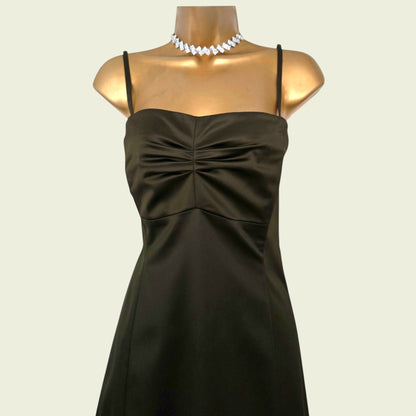 Mannequin wearing an olive green dress on beige background