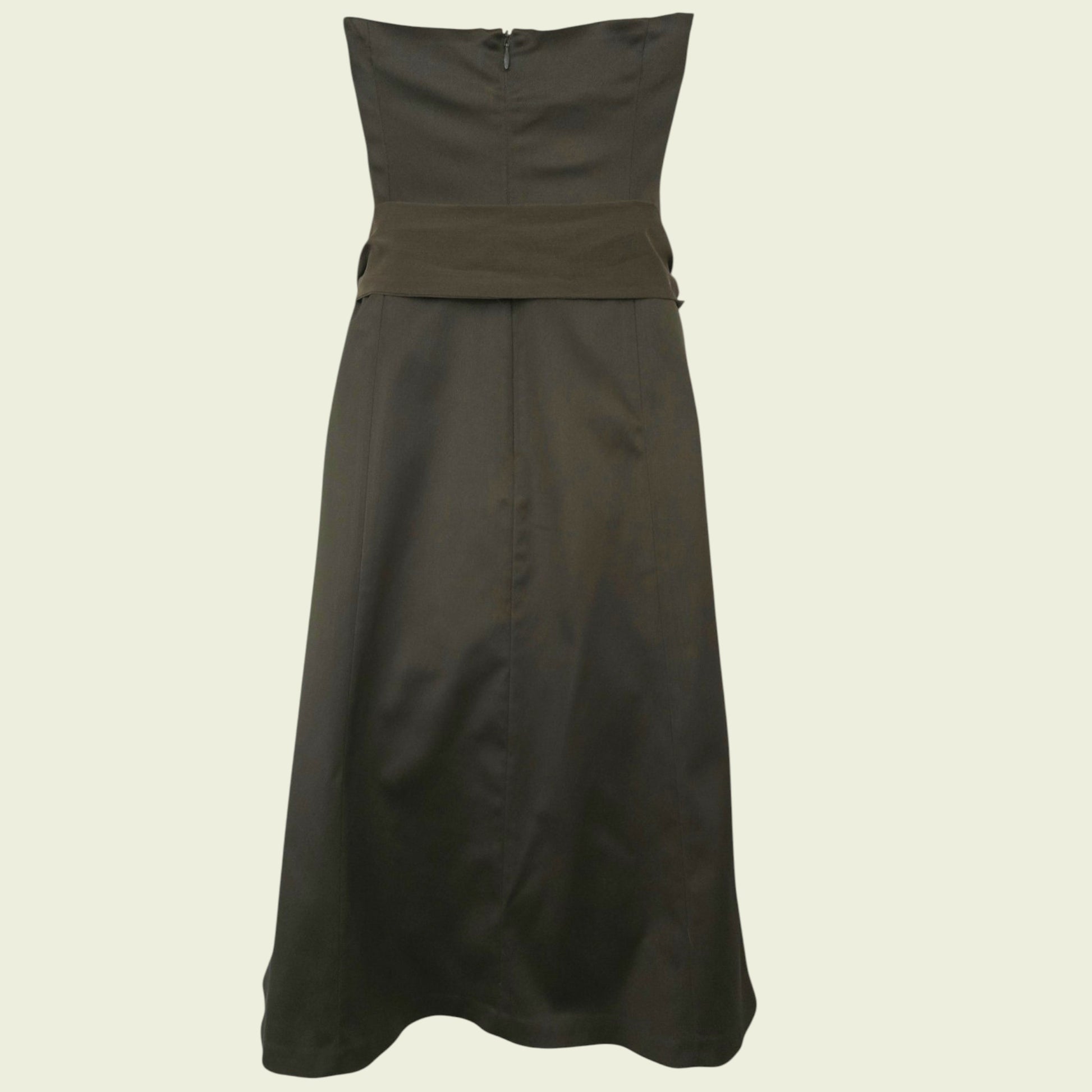 Mannequin wearing an olive green dress on beige background