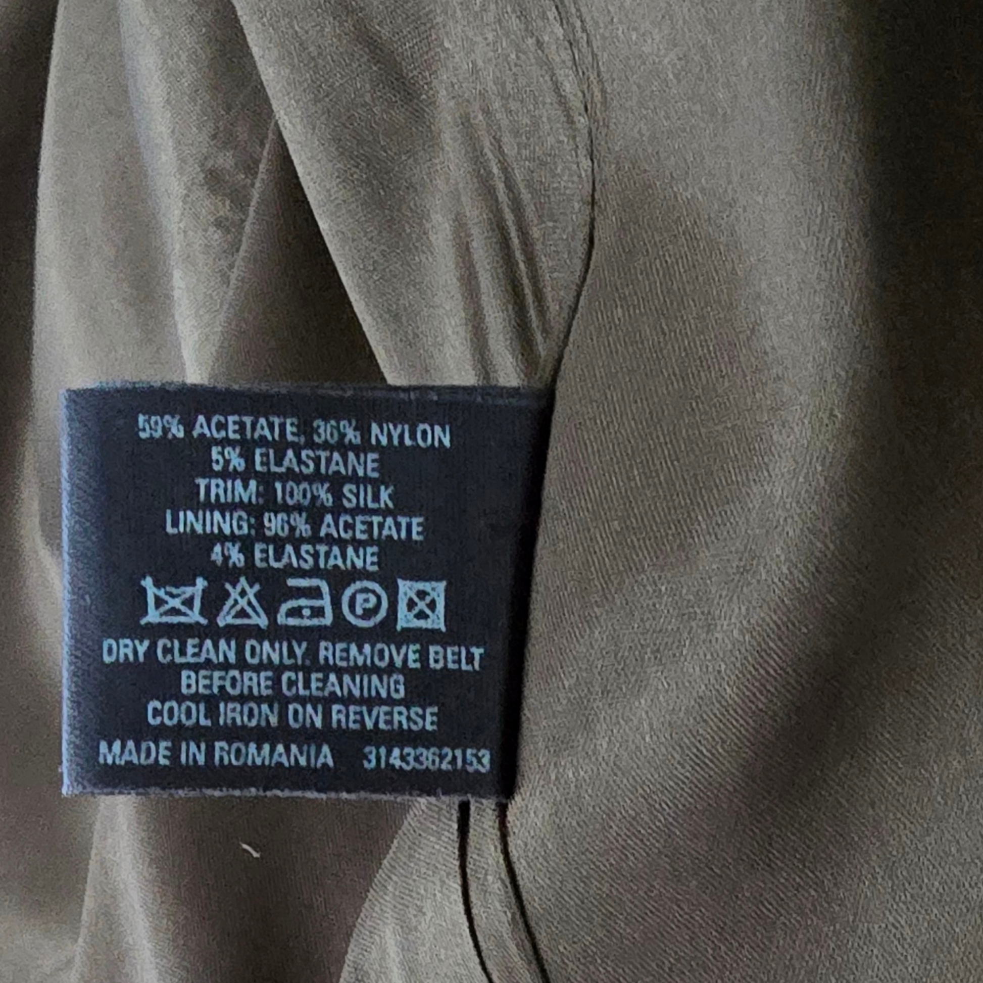 Garment label showing cleaning instructions on green background