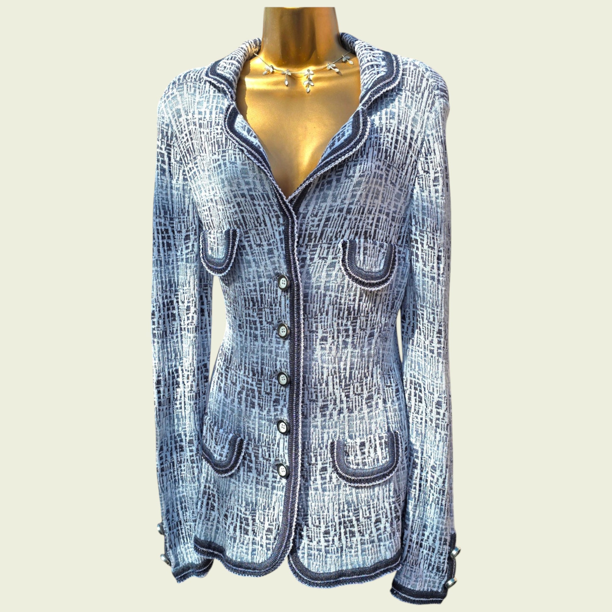 Mannequin wearing blue and white knitted jacket on a beige background