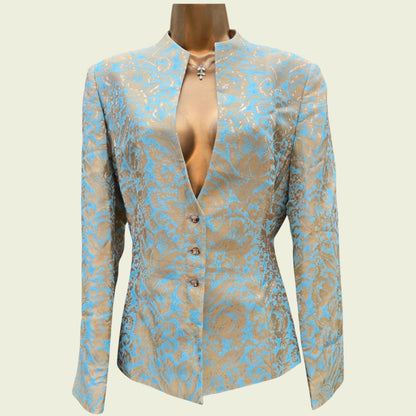Mannequin wearing a light blue and gold jacket on a beige background