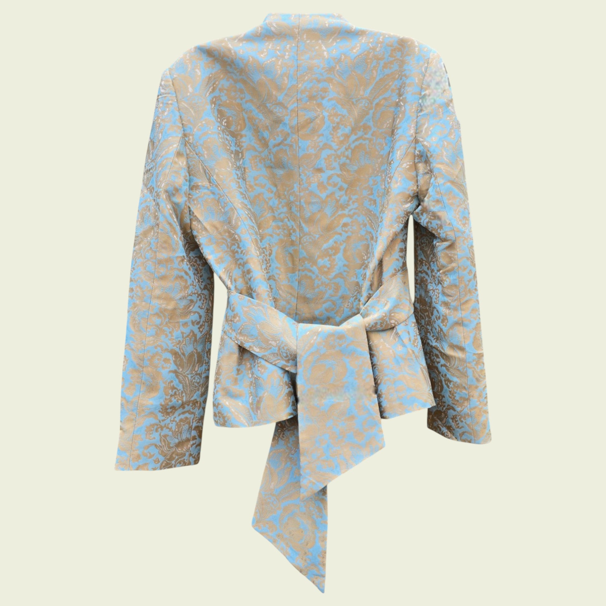 Mannequin wearing a light blue and gold jacket on a beige background
